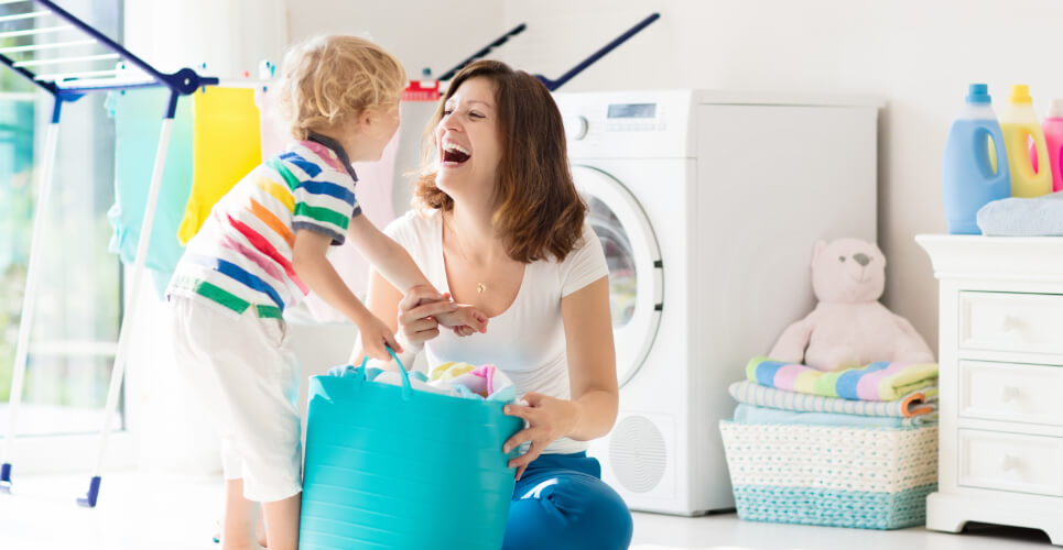 Woman and Child Playing in Laundry Room