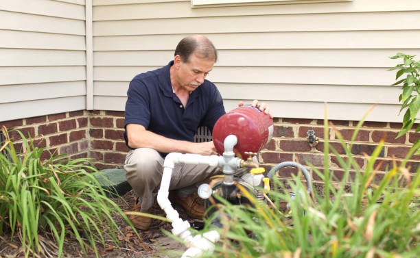 A Man Fixing a Water Pump - H2O Equipment